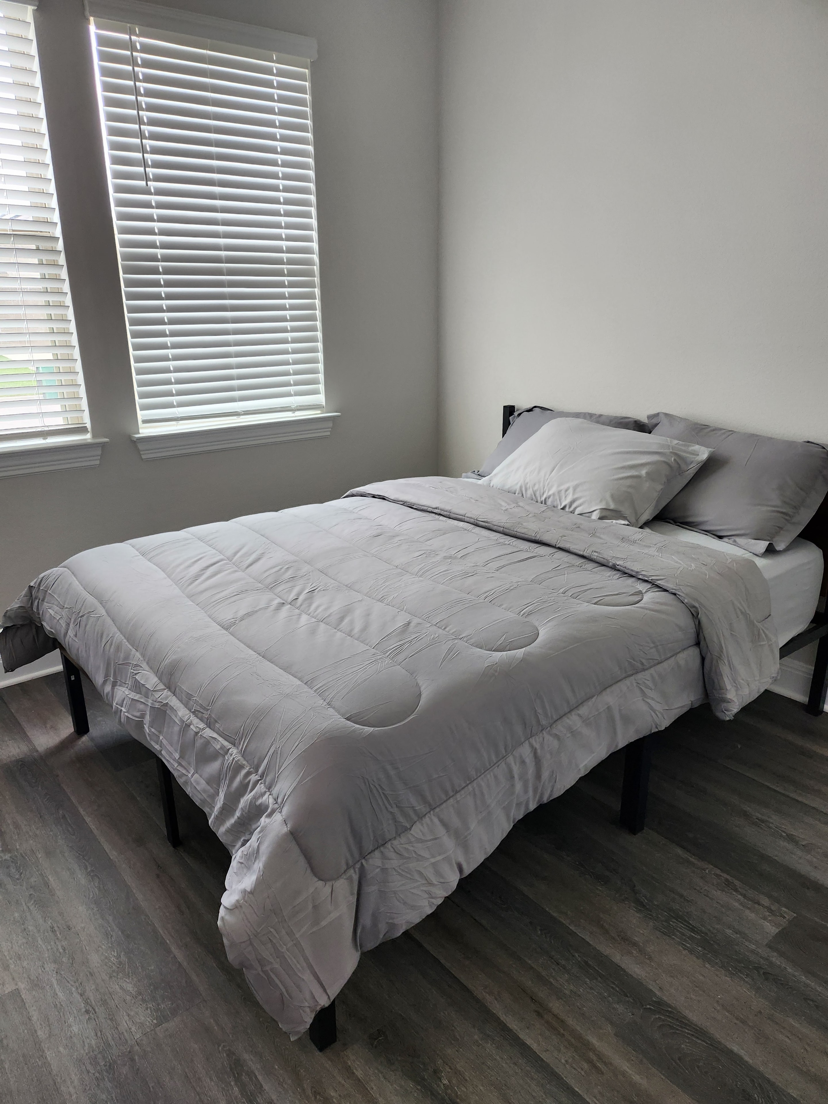 Bedroom with gray bedding and window